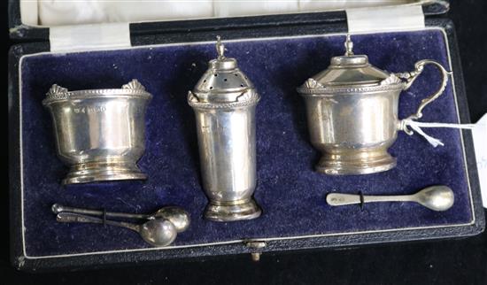 A cased silver three piece condiment set by Walker & Hall, Birmingham, 1934.